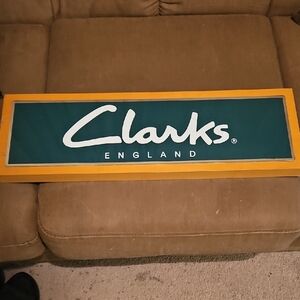 Clarks England Sign with Green and Yellow Frame
